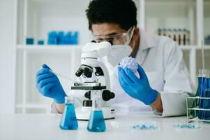 Male biotechnologist testing new chemical substances in a laboratory. photo