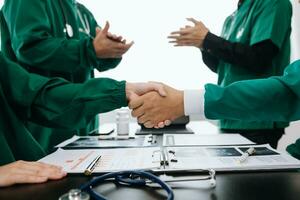 Doctor handshake and partnership in healthcare, medicine or trust for collaboration, unity or support.Team of medical experts shaking hands in teamwork for or success in clinic or hospital photo