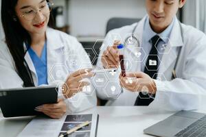 Medical technology network team meeting concept. Doctor hand working with smart phone modern digital tablet and laptop computer with graphics chart interface, with virtual icon diagram photo