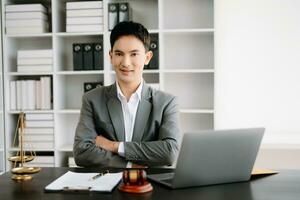 justice and law concept .Asian Male judge in a courtroom on table and Counselor working in office. photo