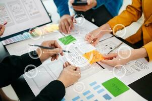 UX developer and ui designer brainstorming about mobile app interface wireframe design with customer breif and color code at office. photo