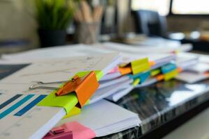 A huge stacked documents is an annual earnings summary document prepared for business people to use in attending meetings and this stacked paper is also an important document. photo