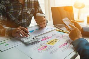 Businessmen and investors form a group of startups and business plans together in a meeting room. A group of startup entrepreneurs are discussing investment plans and profits. photo