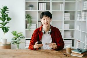 Man using smart phone for mobile payments online shopping,omni channel,sitting on table photo