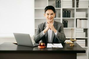 justice and law concept .Asian Male judge in a courtroom on table and Counselor working in office. photo