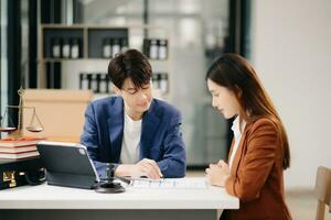 Business people compassionately holding hands and discussing contract papers with laptop and tabletat in office room. photo