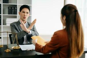 Lawyer refusing bribe money in the envelop from business man at the lawyer modern office. photo