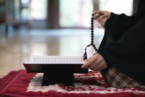 muslim women in hijab are praying to show respect and thanks to allah according to muslim belief and muslim women in hijab are praying to allah according to traditional belief from quran photo