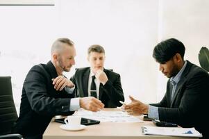 Business team discuss at meeting room. working together with laptop ,tablet and smart phone on desk Financial accountant , planner , meeting , introduction concept. At office photo