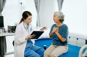 Caucasian doctor smiling take care of a young patient in hospital. Friendly nurse or therapeutic treat client Professional medical service concept. photo