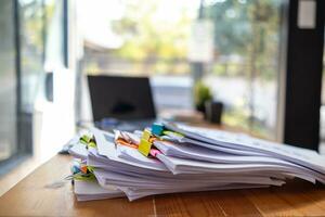 A huge stacked documents is an annual earnings summary document prepared for business people to use in attending meetings and this stacked paper is also an important document. photo