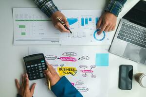 Businessmen and investors form a group of startups and business plans together in a meeting room. A group of startup entrepreneurs are discussing investment plans and profits. photo