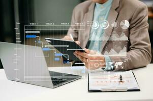 Project manager working and update tasks with milestones progress planning and Gantt chart scheduling diagram. business working with smart phone, tablet and laptop in office. photo