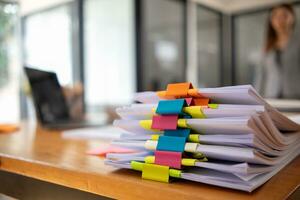 A huge stacked documents is an annual earnings summary document prepared for business people to use in attending meetings and this stacked paper is also an important document. photo