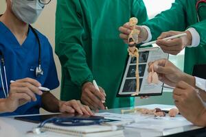 concept of mobilizing ability of medical team in conference room to diagnose and treat disease correctly. medical team joins meeting and discusses  patient illness in order to treat it correctly photo