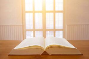 Law books lying open on table in lawyer office are legal books containing legal statutes and court judgments to be used in arguing and prosecuting accused. concept of learning law and understanding photo