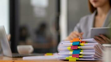 A huge stacked documents is an annual earnings summary document prepared for business people to use in attending meetings and this stacked paper is also an important document. photo