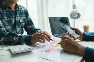 A group of investors and business teams are discussing investment trends for the best results. The concept of hiring an investment consultant to get highly efficient investment advice. photo