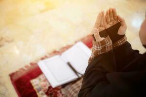 muslim women in hijab are praying to show respect and thanks to allah according to muslim belief and muslim women in hijab are praying to allah according to traditional belief from quran photo