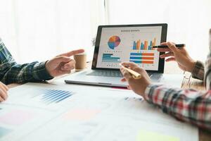 A group of investors and business teams are discussing investment trends for the best results. The concept of hiring an investment consultant to get highly efficient investment advice. photo