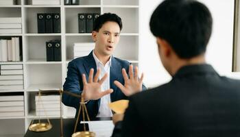 Lawyer refusing bribe money in the envelop from businessman at the lawyer office. photo