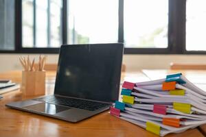 A huge stacked documents is an annual earnings summary document prepared for business people to use in attending meetings and this stacked paper is also an important document. photo
