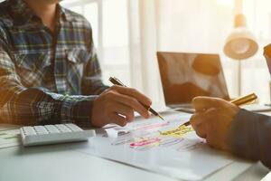 A group of investors and business teams are discussing investment trends for the best results. The concept of hiring an investment consultant to get highly efficient investment advice. photo