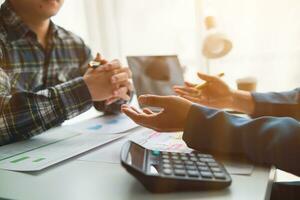 A group of investors and business teams are discussing investment trends for the best results. The concept of hiring an investment consultant to get highly efficient investment advice. photo