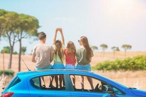 Parents and two little kids on summer car vacation photo