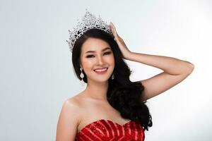 Portrait of Miss Pageant Contest in Asian Red Sequin Evening Ball Gown dress with Silver Diamond Crown Sash, fashion make up face hair style, studio lighting white background isolated copy space photo
