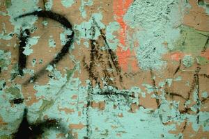 Scribbled graffiti on an old dilapidated wall photo