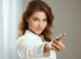 Young girl looking at camera while pointing her finger photo