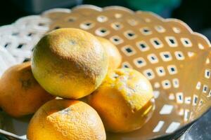Fresh and ripe sunkist oranges fruits. Served in rattan basket. photo