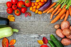 Assortment different fresh organic vegetables on country style wooden background. Healthy food vegan vegetarian dieting concept. Local garden produce clean food. Frame top view flat lay copy space. photo