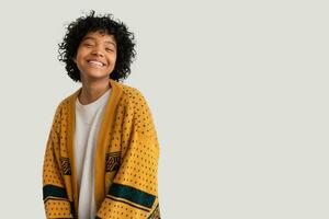 Beautiful african american girl with afro hairstyle smiling isolated on white background with copy space. Young african woman with curly hair laughing. Freedom happiness carefree happy people concept. photo