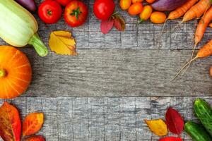 Assortment different fresh organic vegetables on country style wooden background. Healthy food vegan vegetarian dieting concept. Local garden produce clean food. Frame top view flat lay copy space. photo