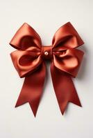 Red gift bow on whitesimple and elegant holiday decoration photo
