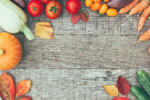 Assortment different fresh organic vegetables on country style wooden background. Healthy food vegan vegetarian dieting concept. Local garden produce clean food. Frame top view flat lay copy space. photo