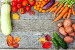 Assortment different fresh organic vegetables on country style wooden background. Healthy food vegan vegetarian dieting concept. Local garden produce clean food. Frame top view flat lay copy space. photo