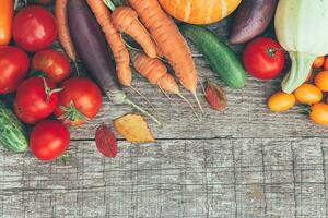 Assortment different fresh organic vegetables on country style wooden background. Healthy food vegan vegetarian dieting concept. Local garden produce clean food. Frame top view flat lay copy space. photo