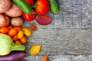 Assortment different fresh organic vegetables on country style wooden background. Healthy food vegan vegetarian dieting concept. Local garden produce clean food. Frame top view flat lay copy space. photo