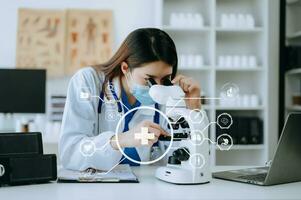 Female scientist researcher conducting an experiment working in the chemical laboratory with VR icons photo