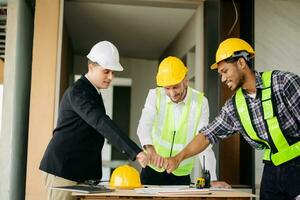 Engineer and contractor join hands after signing contract,They are having a modern building project together. successful cooperation photo