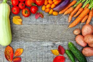 Assortment different fresh organic vegetables on country style wooden background. Healthy food vegan vegetarian dieting concept. Local garden produce clean food. Frame top view flat lay copy space. photo