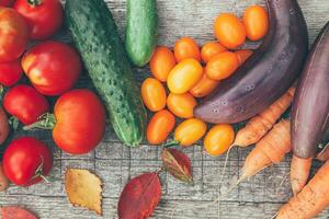 Assortment different fresh organic vegetables on country style wooden background. Healthy food vegan vegetarian dieting concept. Local garden produce clean food. Frame top view flat lay copy space. photo