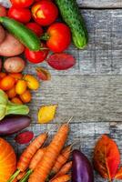 Assortment different fresh organic vegetables on country style wooden background. Healthy food vegan vegetarian dieting concept. Local garden produce clean food. Frame top view flat lay copy space. photo