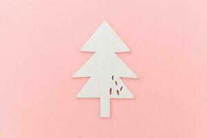 Simply minimal composition winter objects ornament fir tree isolated on pink pastel trendy background photo