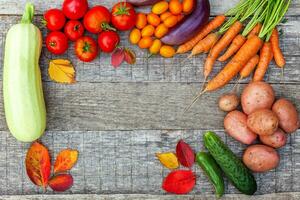 Assortment different fresh organic vegetables on country style wooden background. Healthy food vegan vegetarian dieting concept. Local garden produce clean food. Frame top view flat lay copy space. photo