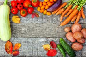 Assortment different fresh organic vegetables on country style wooden background. Healthy food vegan vegetarian dieting concept. Local garden produce clean food. Frame top view flat lay copy space. photo