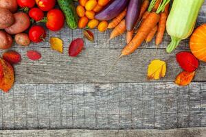 Assortment different fresh organic vegetables on country style wooden background. Healthy food vegan vegetarian dieting concept. Local garden produce clean food. Frame top view flat lay copy space. photo